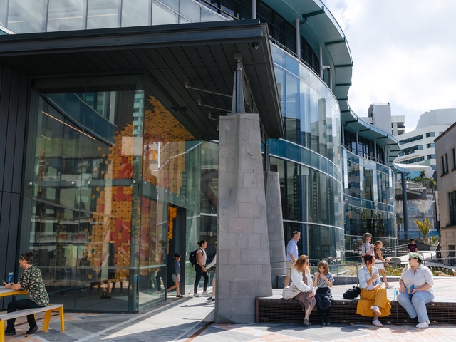 people sitting outside building, or exiting building
