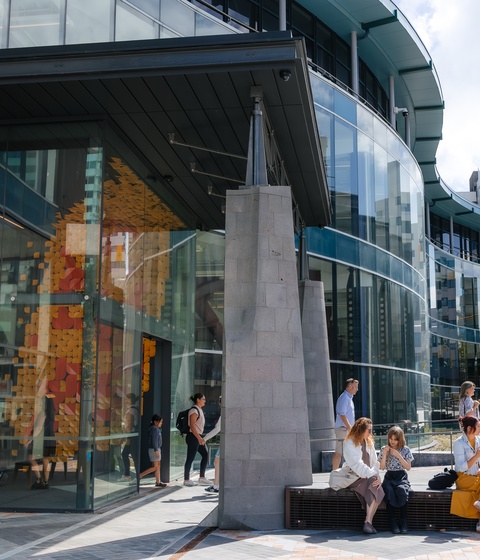 people sitting outside building, or exiting building